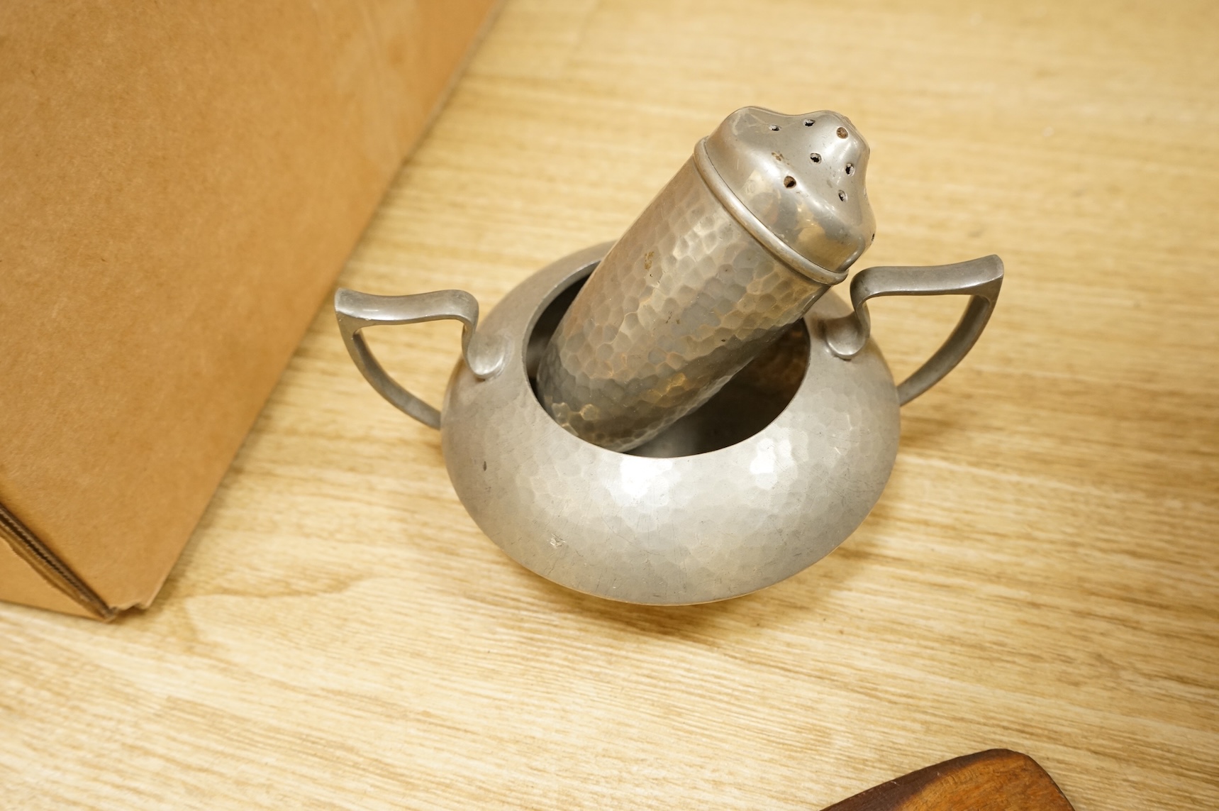 A Hutton, Sheffield English Pewter tea set comprising a teapot, 8cm high, jug and sugar bowl, together with salt and pepper shakers by other makers, a copper coal scuttle and two American mesh fire screens, coal scuttle